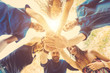 Group of friends with hands on stack and looking down Group of friends with hands on stack and looking down