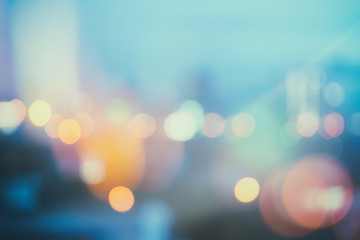 abstract background with bokeh defocused lights and shadow from cityscape at night, vintage or retro color tone
