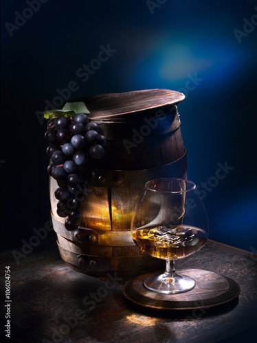 Digestif near barrels with grapes