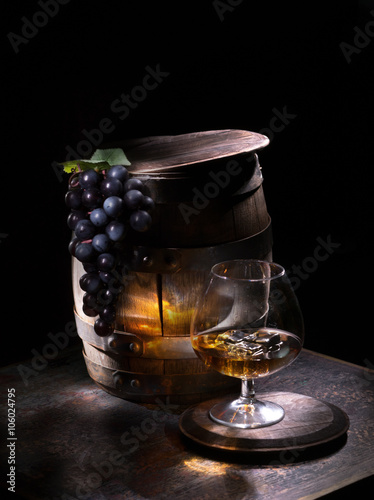 Oak barrels with grapes and brandy with ice
