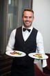 Portrait of waiter presenting meals Portrait of waiter presenting meals