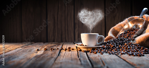 Traditional Coffee Cup With Heart-Shaped Steam On Rustic Wood