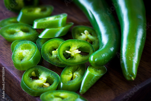 Fresh green chilli on old wooden background