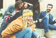 Group of four friends laughing out loud outdoor, sharing good an Group of four friends laughing out loud outdoor, sharing good an