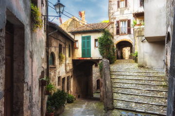 Spring streets of the old Tuscan town. Colorful flowers bloom 