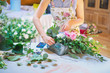 Hands of florist woman creating bouquets for wedding decoration Hands of florist woman creating bouquets for wedding decoration