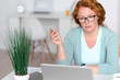 Concentrated senior woman sitting at the table Concentrated senior woman sitting at the table