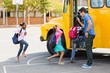 Teacher giving high five to kids while entering in bus Teacher giving high five to kids while entering in bus
