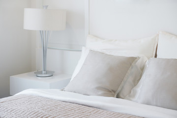 Light gray pillow setting on bed in nice vibe bedroom modern interior style