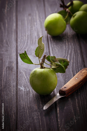 Green apples on wooden background