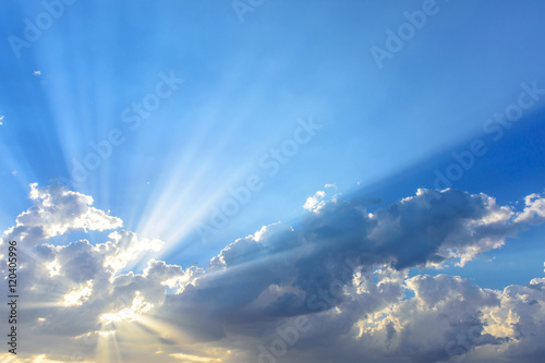 Fototapeta Sun beams or light rays breaking through the clouds. Beautiful s