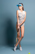 fashion female model in in swimsuit body with tennis racquet on blue background fashion female model in in swimsuit body with tennis racquet on blue background
