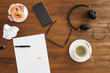 Desktop scene with notes, coffee stain, coffe, headphones and music shot from above Desktop scene with notes, coffee stain, coffe, headphones and music shot from above