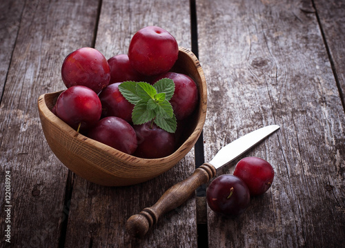 Sweet plums on wooden background