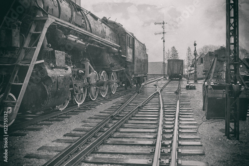 The stylized image of an old steam locomotive at the station