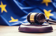 Judges wooden gavel with EU flag in the background. Symbol for jurisdiction. Judges wooden gavel with EU flag in the background. Symbol for jurisdiction.