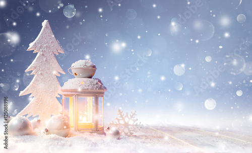 White Christmas Decoration With Lantern On Snowy Table And Shiny Snowfall
