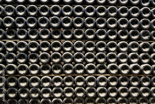 Bottles of sparkling wine in a cellar are put at each other. Bottles of sparkling wine in a cellar are put at each other.