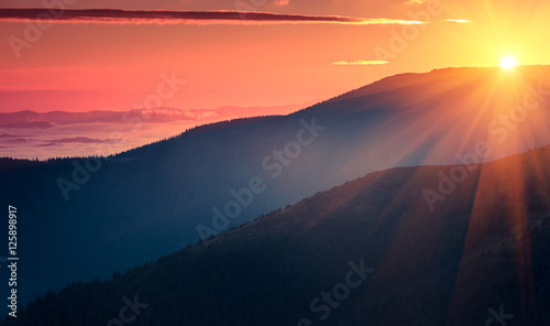 Panoramic view of  colorful sunrise in mountains. Filtered image:cross processed vintage effect.