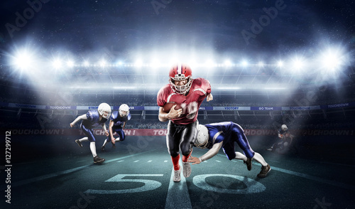  American football players in action on stadium with ball