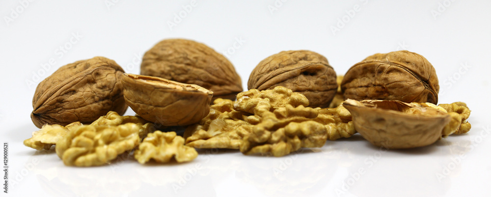 Walnut and a cracked walnut on the white background