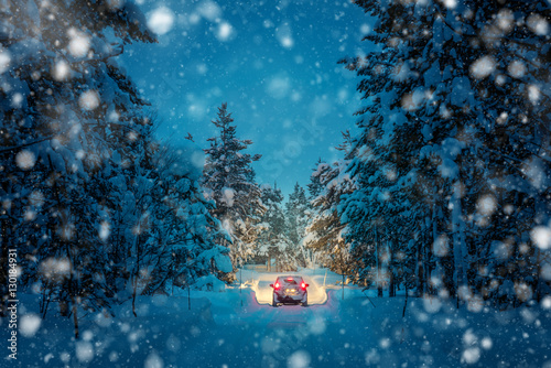 Zdjęcie XXL Winter Driving at snowfall night - Światła samochodu w zaśnieżonej drodze