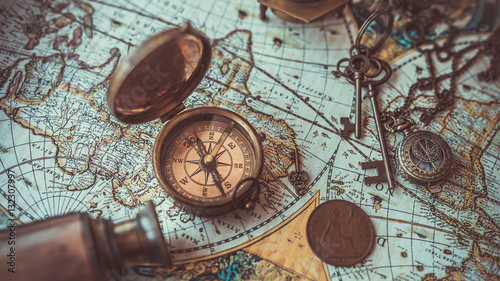 Old collection compass, telescope and collecting rare items on antique world map. (vintage style)  © Aris Suwanmalee