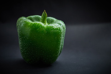 Fresh green pepper on black background