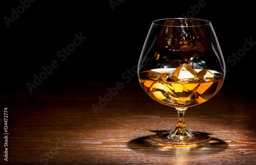 whiskey with ice on a wooden table