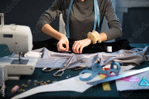 Tailor sew white thread black and gray cloth