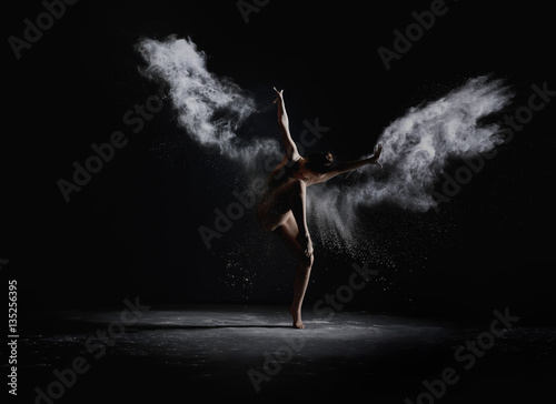 Obraz Fotograficzny Slender girl dancing in white dust cloud