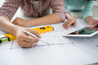 Attractive young asian adult couple looking at house plans. Attractive young asian adult couple looking at house plans.