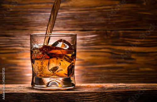 whiskey with ice on a wooden table
