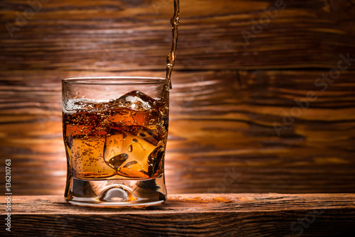 whiskey with ice on a wooden table