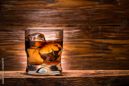 whiskey with ice on a wooden table