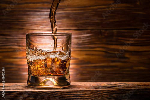 whiskey with ice on a wooden table