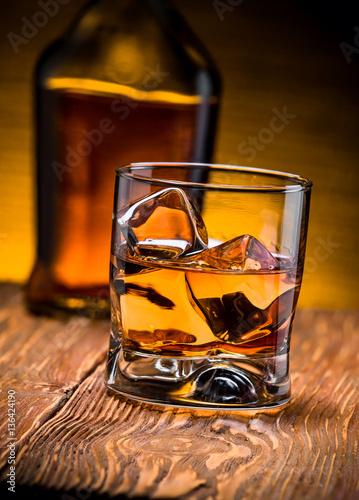 whiskey with ice on a wooden table