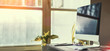 Computer on desktop in hipster workplace office - no people Computer on desktop in hipster workplace office - no people
