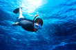 young man snorkeling down into the deep blue ocean sea background young man snorkeling down into the deep blue ocean sea background