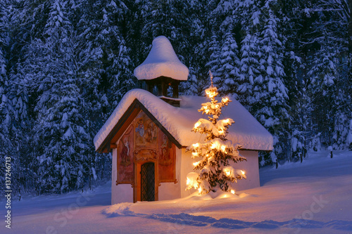 Illuminated Christmas tree in front of a chapel in winter, Bavaria, Upper Bavaria, Germany, Europe © pwmotion