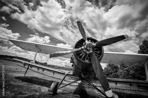 Fototapeta Old airplane on field in black and white