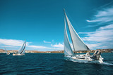 Luxury yachts at regatta. Sailing through the waves at the Aegean Sea.