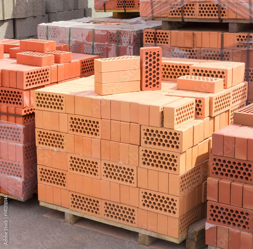 Perforated yellow and red bricks with round holes