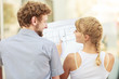 couple with blueprint project building plans outdoor couple with blueprint project building plans outdoor