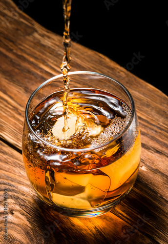 whiskey with ice on a wooden table