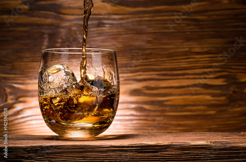 whiskey with ice on a wooden table