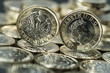 new pound coin introduced in Britain in 2017, front and back, on a layer of coins new pound coin introduced in Britain in 2017, front and back, on a layer of coins