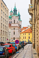 Street with St Nicholas Church in Lesser Town Square Prague