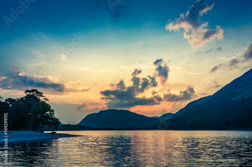Stunning colorful dusk at lake in District Lake, United Kingdom