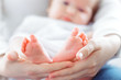 Young mother and newborn baby in white bedroom Young mother and newborn baby in white bedroom